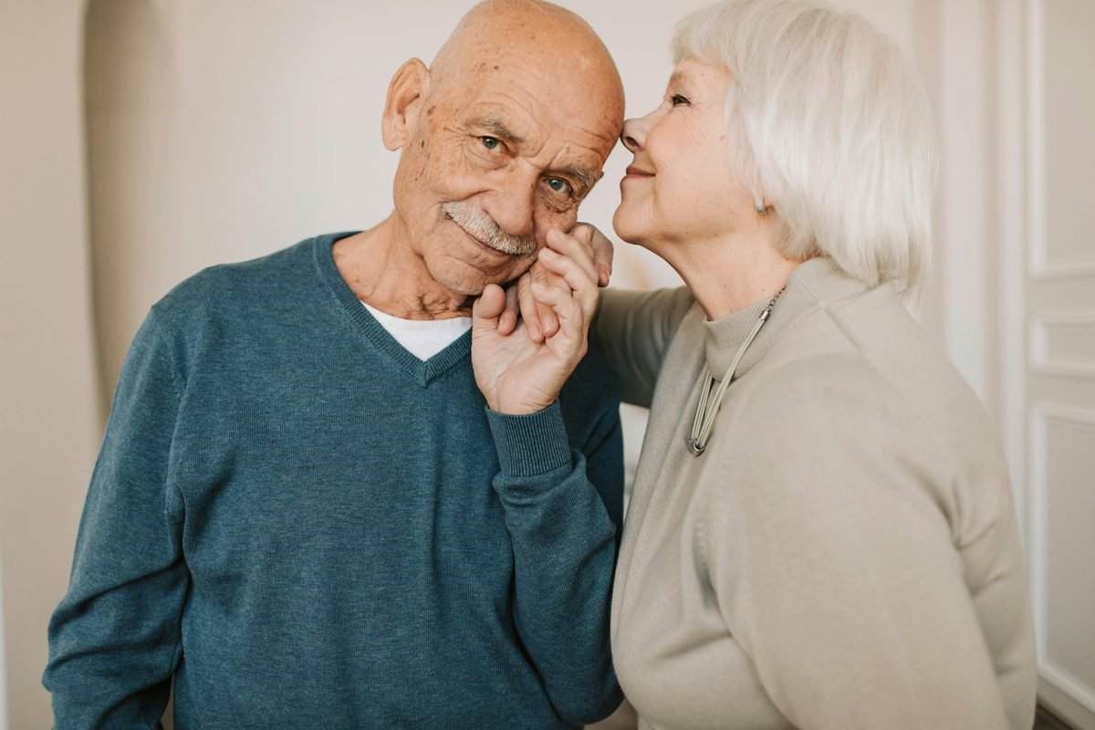 An older couple sharing an affectionate, intimate moment